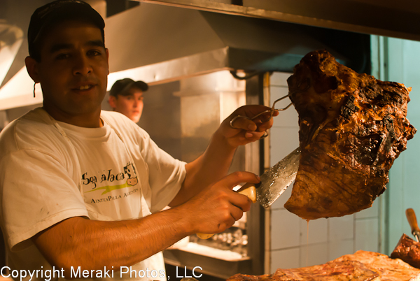 Photo of grillmaster holding up a giant slab of meat